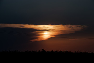 orange sunset through the clounds