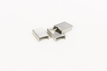 Three blocks of staples for stapler on white background.