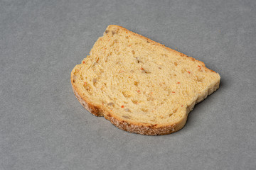 A slice of bread on grey background