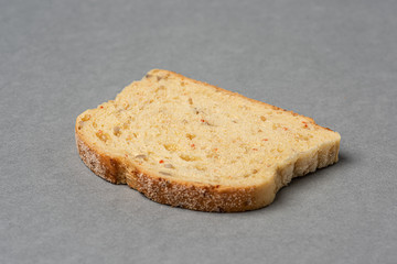 A slice of bread on grey background