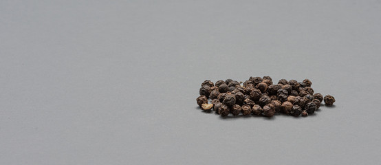 Black pepper on grey background.