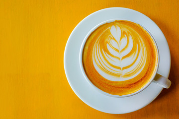 Latte Coffee art on the wooden table yellow