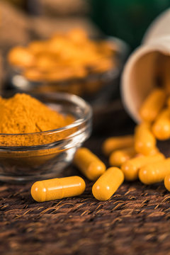 Curcumin Herbal Supplement Capsules And Turmeric Powder