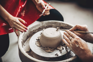 Learning pottery, old hands of teacher. Concept mentor