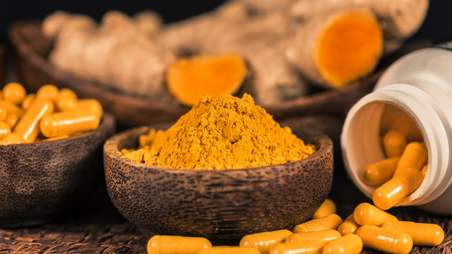 Curcumin Herbal Supplement Capsules and Turmeric Powder