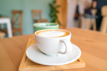 Hot coffee on wooden table