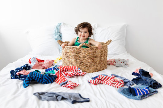 Funny Toddler Sitting In Laundry Basket