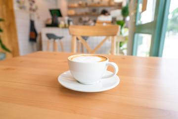 Hot coffee on wooden table