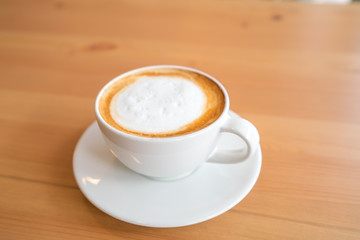 Hot coffee on wooden table