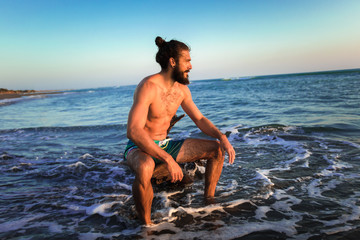 One man on the beach at the sunset.