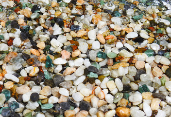 Colorful stones under water. Texture.