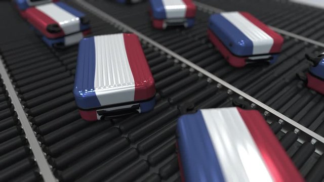 Many travel suitcases featuring flag of the Netherlands on roller conveyor. Dutch tourism conceptual animation