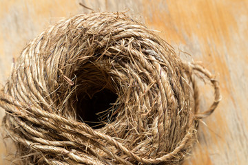Skein ball of jute twine on wooden background, close up, macro