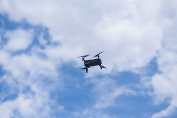 Flying drone against the sky with clouds.