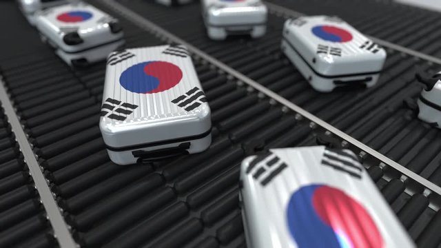Many travel suitcases featuring flag of South Korea on roller conveyor. Korean tourism conceptual animation