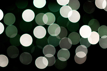 Unfocused abstract colourful bokeh black background. defocused and blurred many round green light