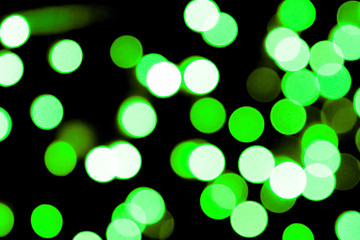 Obraz premium Unfocused abstract colourful bokeh black background. defocused and blurred many round green light