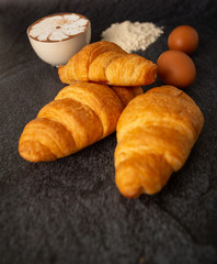 Breakfast with croissant with a cup of white coffee Put on a black background,,breakfast bread brown beverage morning,Concept: meal delicious for healthy,Dessert bakery restaurant  lifestyle area