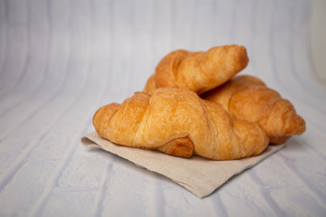 Croissants with coffee cups with flour and eggs on a white background, breakfast, brown bread, morning drinks, fantasy world: delicious food for health, pastries, bakery, restaurants, lifestyle areas