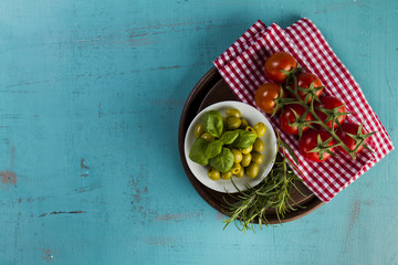 Wooden tray with products on blue surface