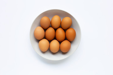 Eggs on white dish, white background.