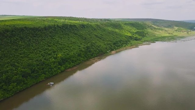 Flying over the river on a sunny summer day. Dniester river of Moldova republic.
