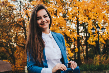 Fototapeta na wymiar young woman in autumn park