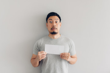 Man is shocked and surprised with the white mail message or the bill.