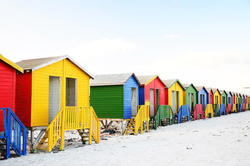 Naklejka premium Multicolored beach huts on Muizenberg beach, Cape Town, South Africa