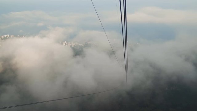 Beautiful view from ropeway car moving up the mountain in Cloudy day
