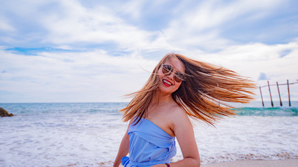 Summer concept travel,Young asian woman with hat on the beach with sunny day in Thailand,Summer concept background.