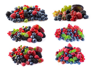 Berries and fruits isolated on white background. Ripe blueberries, blackberries, blackcurrants, raspberries, gooseberries, strawberries and red currants. Mix fruits on white background. 