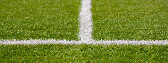 Texture of artificial grass herb cover sports field. It is used in different sports: football,...