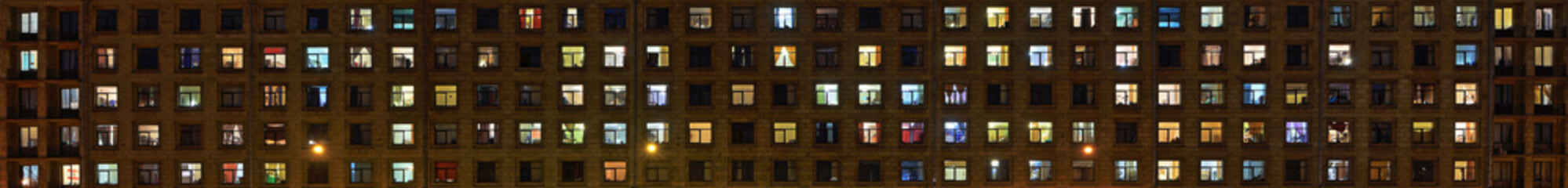 Panorama of the night Windows of the city apartment building