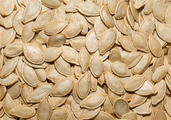 Photo of closeup texture of white pumpkin seeds, background