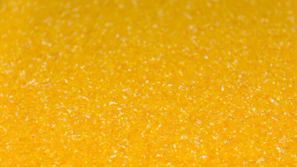 Photo of closeup texture of yellow milled maize cereals, background