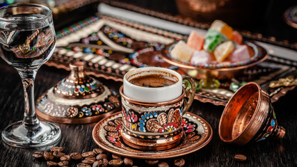 The concept of Turkish cuisine. Turkish brewed black coffee. Beautiful coffee serving in the restaurant. Background image. copy space - obrazy, fototapety, plakaty