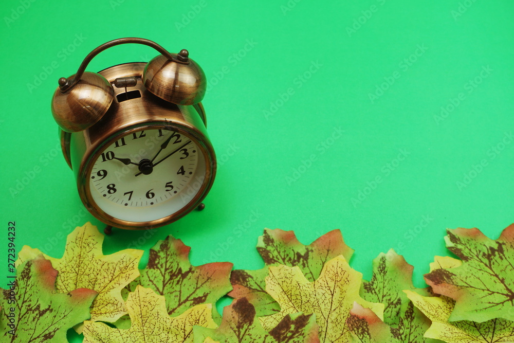 Poster alarm clock with maple leaf boder on green background