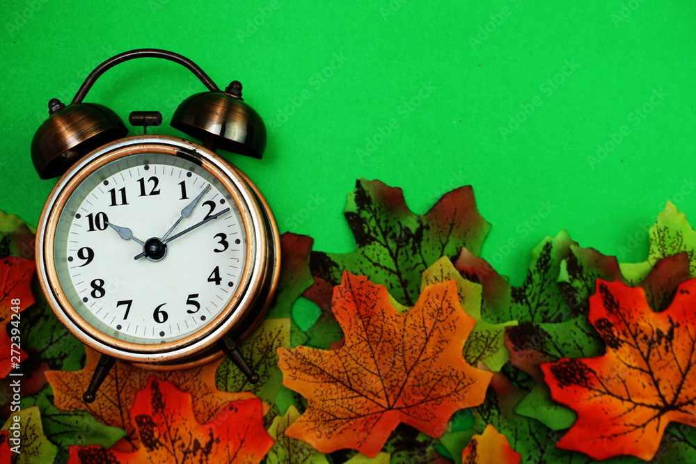 Poster alarm clock with maple leaf boder on green background
