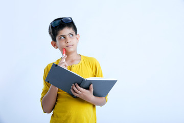 Young indian cute boy with notebook , thinking expression
