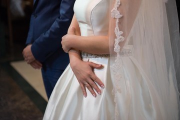bride holding hand showing her wedding ring.