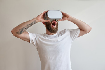 Man hipster with beard using virtual reality glasses