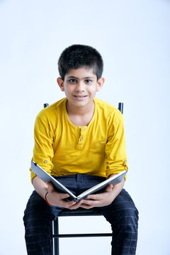 young indin boy holding a notebook 
