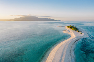 Epic aerial view of tropical island at sunset
