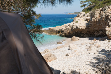 Camping on the beach. Tourist tent by the sea on a sunny day, focus on the tent. Rest away from the...