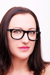 Fototapeta premium Beautiful young woman wearing glasses close-up isolated on white background