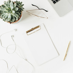 Home office desk workspace with blank copy space clipboard, laptop, headphones, glasses, succulent...