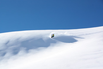 Snowboarder in fine white powder snow