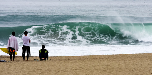 Surfer watching onto the waves
