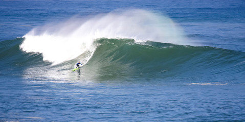 Surfer riding a huge wave